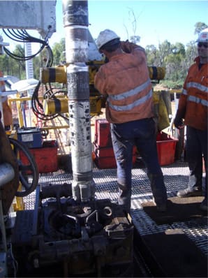 The RMRS sub is located just behind the bit in this picture of a conventional, cantilever drilling rig. You can see the eight slots that contain the bar magnets. When the bit spins, the spinning magnets create an AC magnetic field.